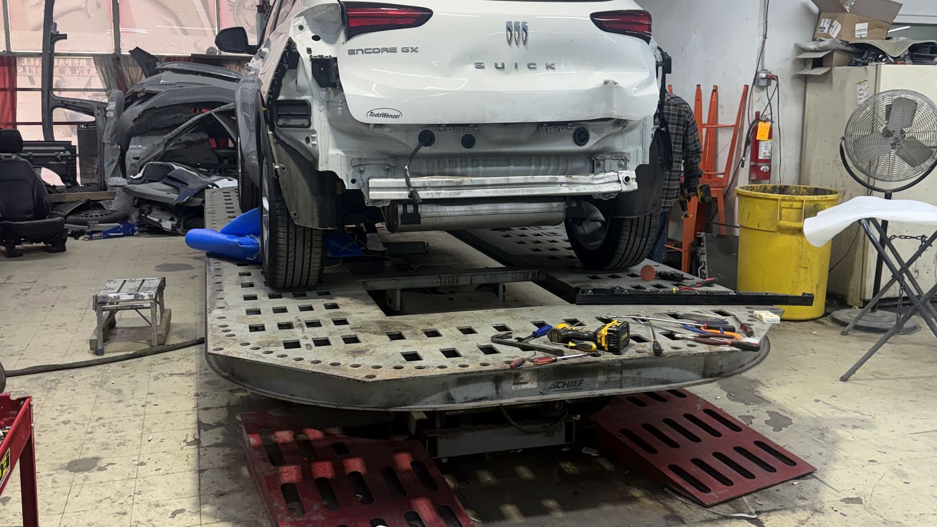 SUV on the frame machine at the 8 Mile collision shop